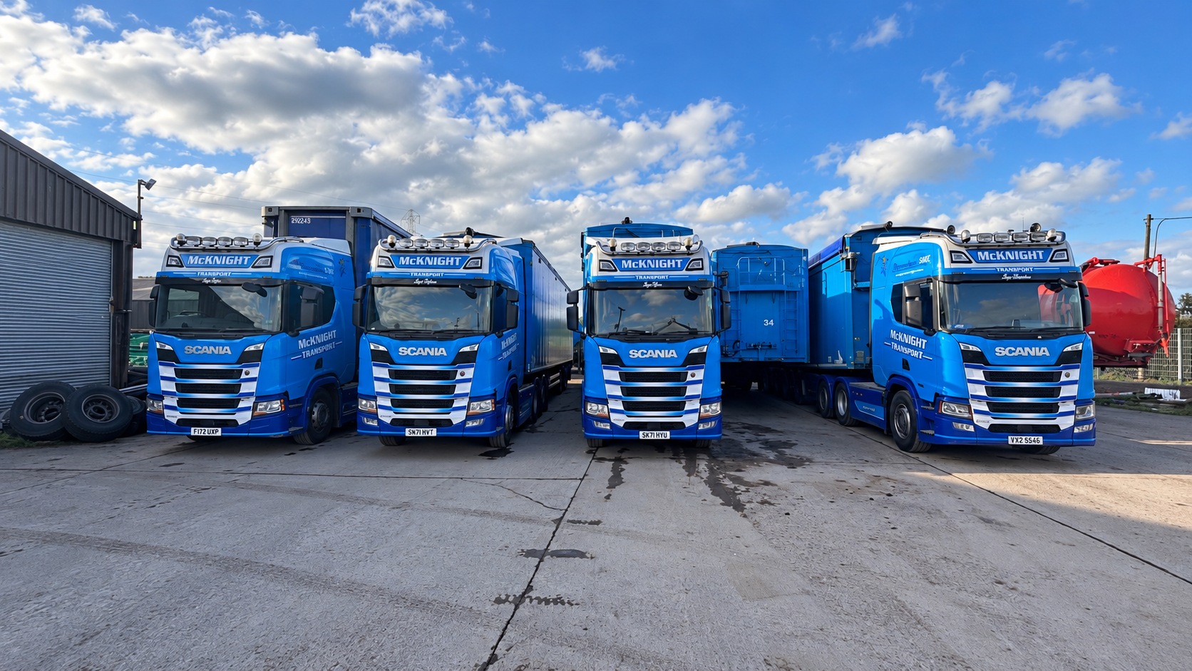 Blue McKnight Scania lorries and trailers lined up in the yard