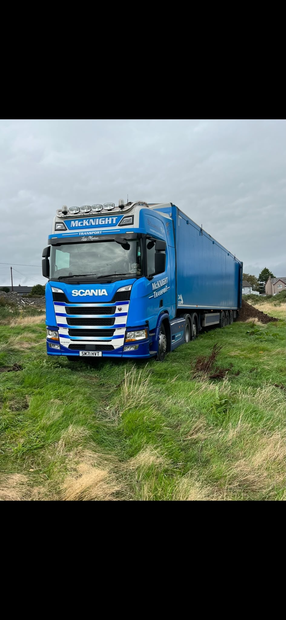 Blue McKnight Scania and bulk trailer at a rural collection setting